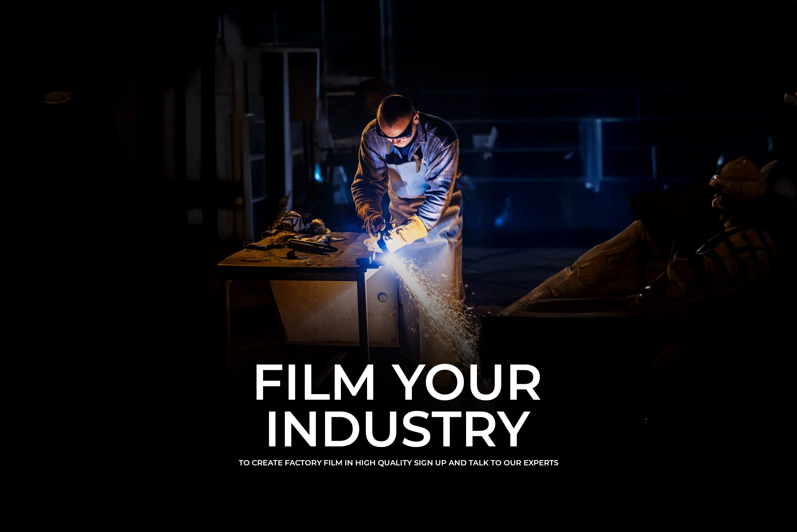 : A high-contrast industrial scene showing a worker in protective gear using a grinding tool on a metal workbench, creating a bright shower of sparks in a dark factory setting. Bold text reads "FILM YOUR INDUSTRY."